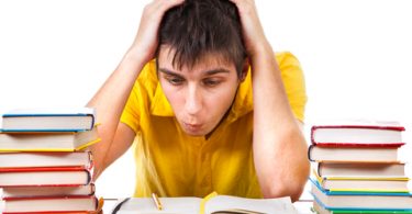 Anxious Troubled Student with Books on the Desk with a White Background