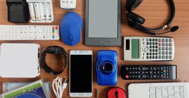 Various technology items for college sitting on a desk