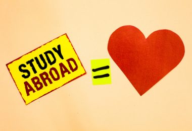 study abroad text with equals sign to red heart on a tan background