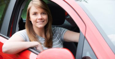 Portrait Of Young Female Driver In Car