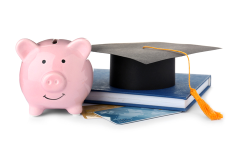 Graduation hat, credit cards and piggy bank isolated on white