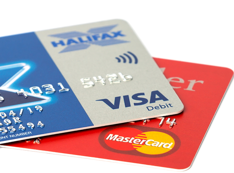 mastercard and visa credit cards sitting on white background